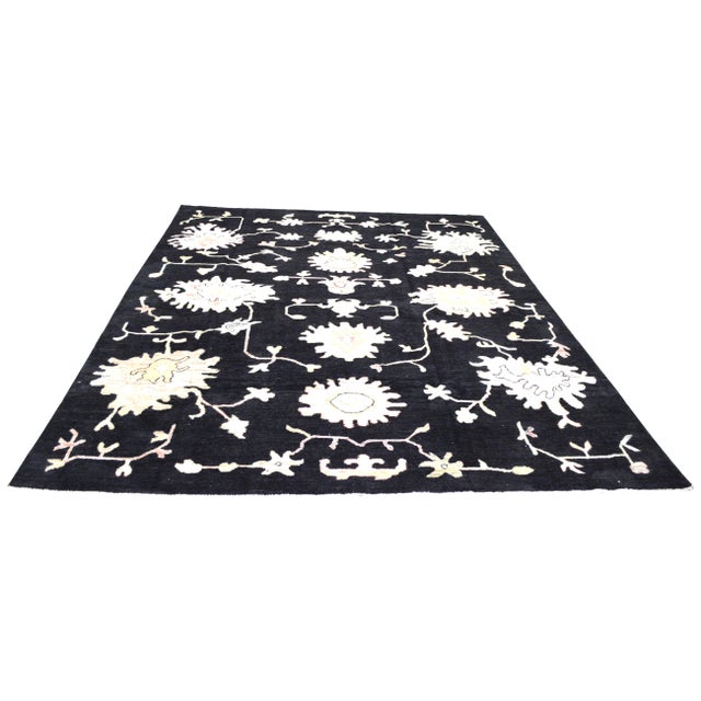 Hand-knotted with care using traditional rug making techniques, this wool rug blends timeless craftsmanship with a modern...