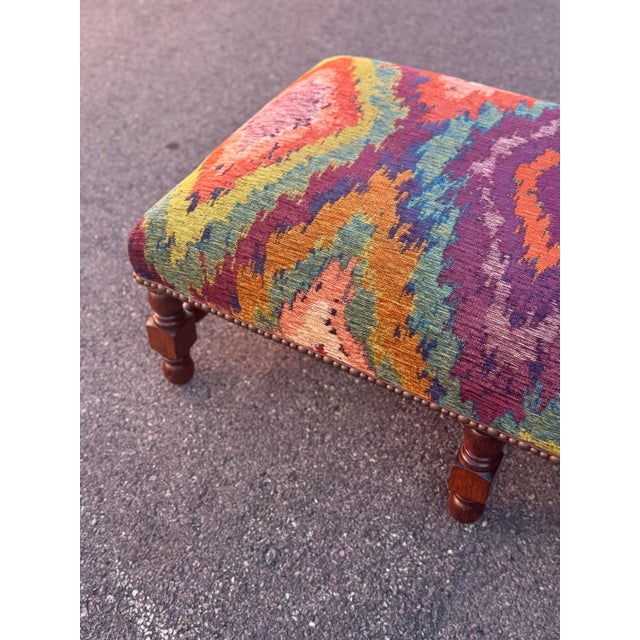 A one-of-a-kind vintage ottoman upholstered in a richly colored kilim textile, featuring a striking geometric pattern in...