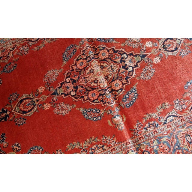 Handmade antique Persian Sarouk rug in original good condition. The rug is from the beginning of 20th century made in...