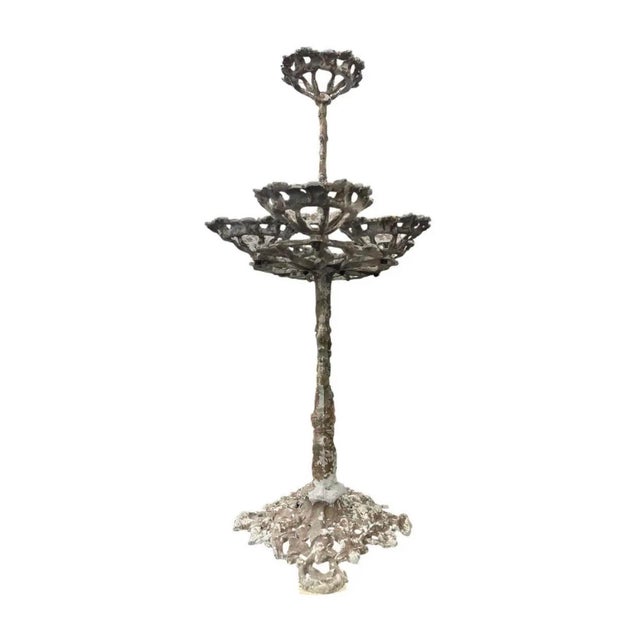 Exuding timeless garden charm and architectural presence, this multi-tier vintage cast iron plant stand features an...