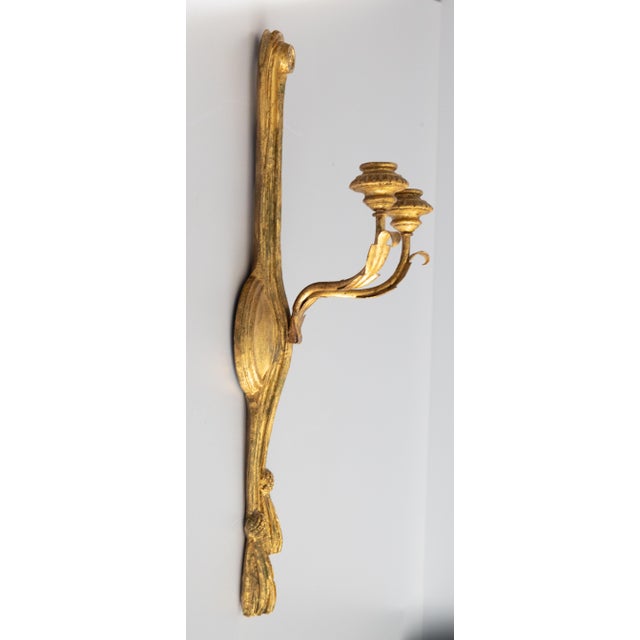 A lovely vintage Mid-Century Italian Florentine gilded wood and tole two arm candle wall sconce, circa 1950. This gorgeous...