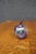 Hand-blown art glass apple featuring a frosted iridescent finish with controlled bubble decoration and a cobalt blue stem...