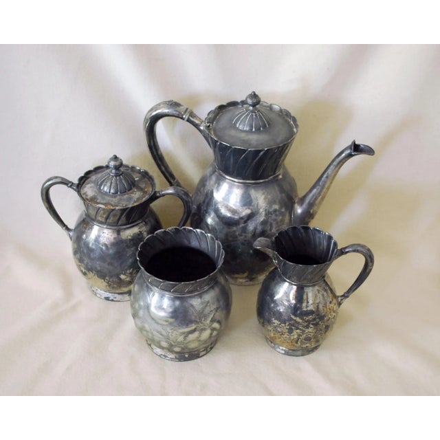 This antique Victorian silver plate tea set by Meriden Brittania, dating to about the 1870s, has a wonderful repousse and...