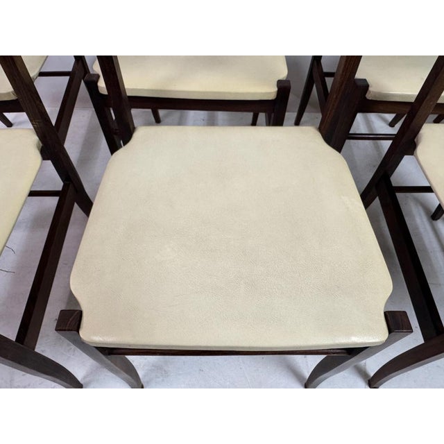 This elegant set of eight 1960s Italian dining chairs showcases refined mid-century craftsmanship and beautifully balanced...