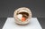 A handmade ceramic sculpture consisting of a large, open shell-like form with layered circular structures and an exposed...