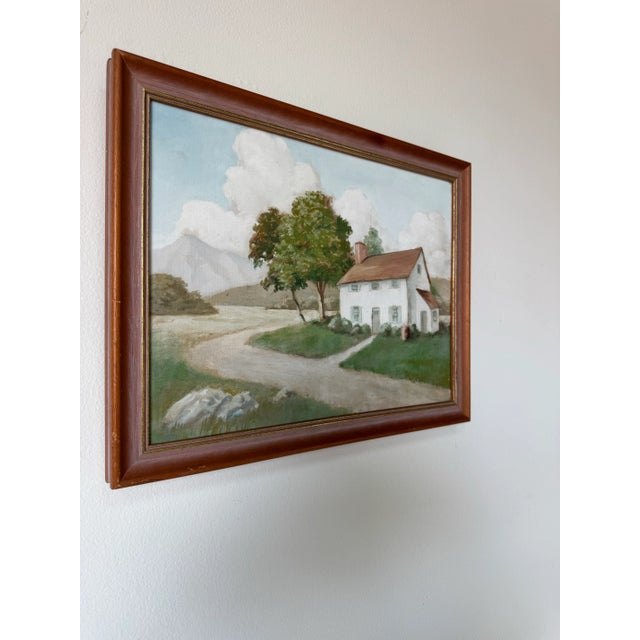 A charming vintage oil painting from the 1980’s depicting a peaceful countryside setting. The composition features a...