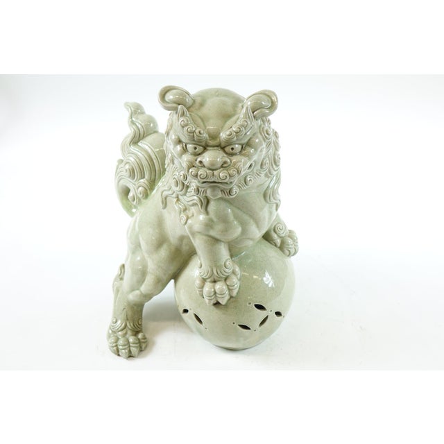 This Large Antique Chinese Celadon Porcelain Foo Lion, measuring 14” x 12.5” x 17”, is a magnificent representation of...