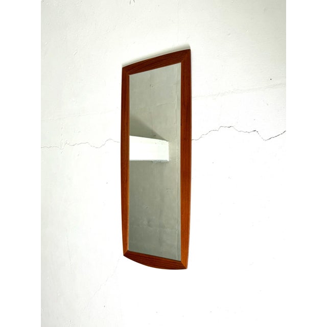 Teak Framed Mirror – Denmark, 1960s A beautiful and timeless Danish teak framed mirror from the 1960s. The gently curved...