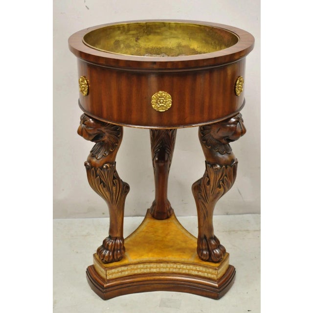 Maitland Smith Regency Style Mahogany Carved Lion Leather Base Cellarete Planter. Item features a tooled leather base,...