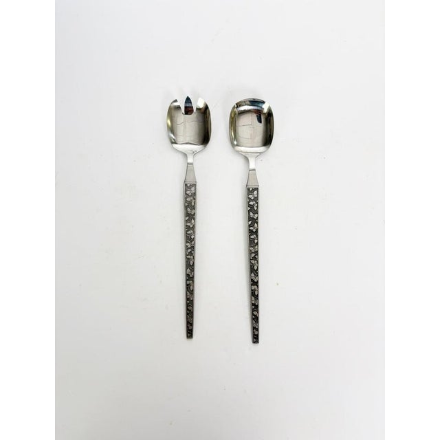 Elegant pair of French salad servers crafted in polished metal with elongated handles featuring an Art Deco-inspired...