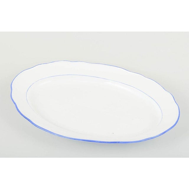 Meissen serving platter in white-glazed porcelain with scalloped rim and blue trim. manufacturer: meissen, germany...