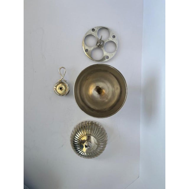 Silver plate egg warmer with the warming element. Will hold four eggs. Made in England. The top is dome and segmented...