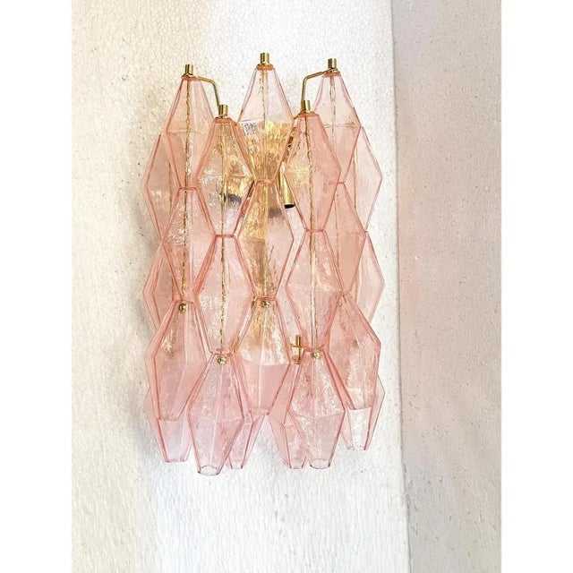 Contemporary and luxury wall sconce with pink “poliedri” in venini style. "poliedri" glass elements are blown inside a...