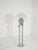 A space age floor lamp from the 1970s, featuring a large murano glass globe diffuser, often associated with the designs of...