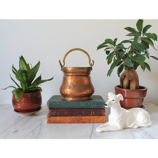Vintage hand forged copper pot or small cauldron featuring a curved brass swing handle with etching detail. No makers...