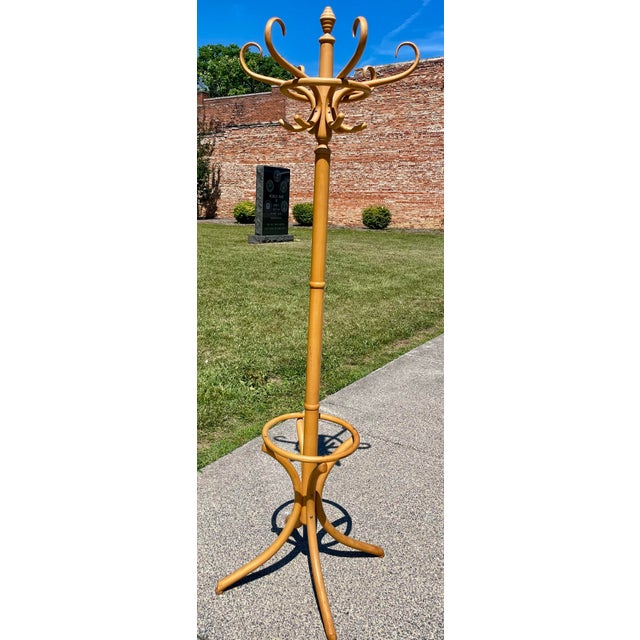 This is a simple but elegant and very useful bamboo hat or coat rack or hall tree with a ring around the lower portion to...