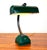 A vintage art deco style desk or banker’s lamp circa 1940’s featuring a heavy adjustable bronze arm and tilting shade....