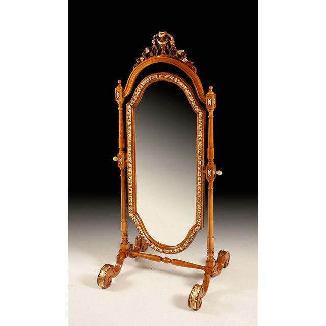 Handcrafted in Italy, this full-length cheval mirror features a walnut frame with hand-carved details and gold leaf...