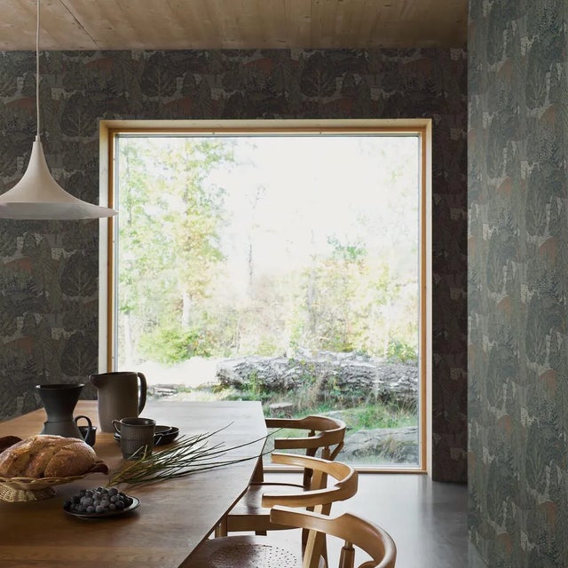 A stylized composition of trees and rolling hills, Boråstapeter’s Northern Forest wallpaper evokes the tranquil beauty of...