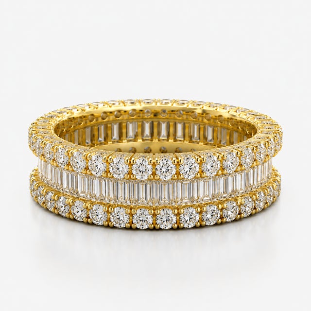 A dramatic interpretation of the eternity band, this 14K Yellow Gold ring combines natural diamonds in a continuous...
