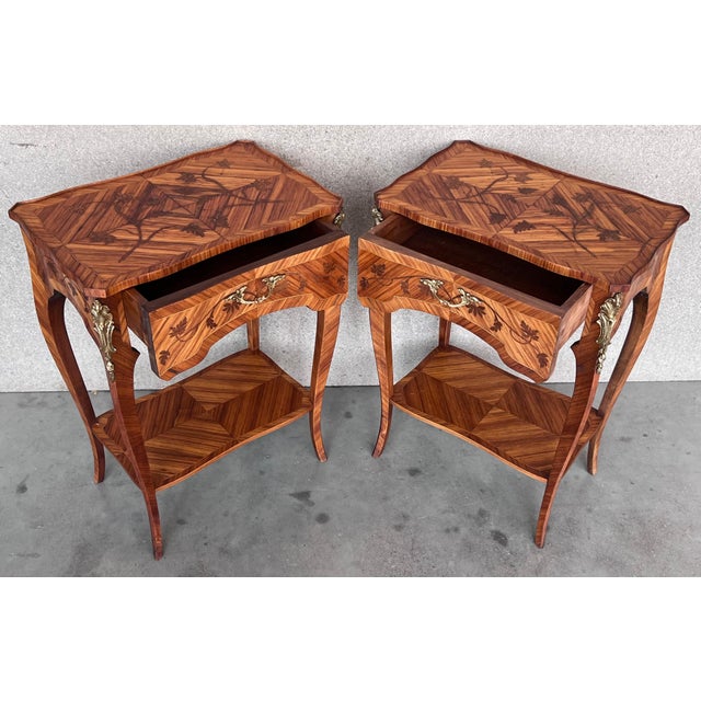 A very fine Louis XV French Style side tables or nightstands with elegant marquetry work, all original restored. This...