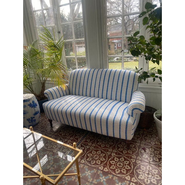 Comfy and spacious loveseat for a sunporch or kitchen. Fresh blue ticking, fade resistant upholstery. In excellent...