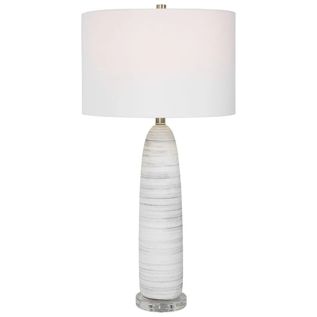 This Sleek Ceramic Table Lamp Features A Matte White Glaze With Brushed Light Gray Detailing, Paired With Brushed Nickel...