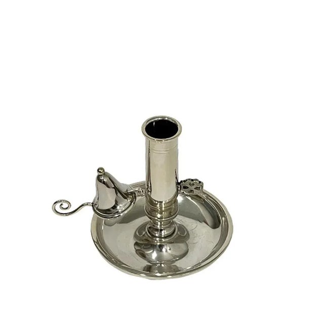 A small silver chamber candlestick with a separate candle extinguisher, which is hung with a hook. With slide in the stem...