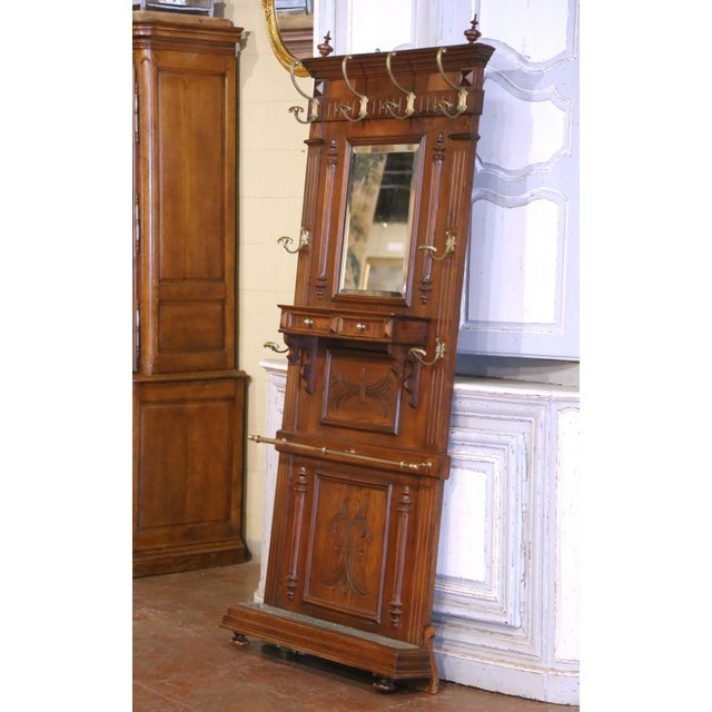 Add classical elegance and practical charm to an entryway or mudroom with this richly carved antique hall tree. Crafted in...