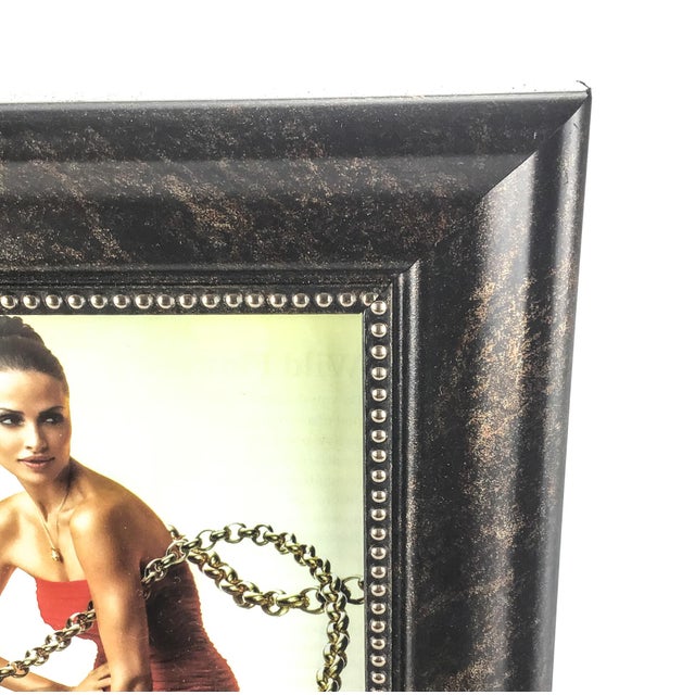 Very cool photo frame with gold nailhead detail. Sits on a shelf or hangs on the wall in either direction.