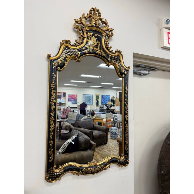 A large exquisite chinoiserie mirror in ebonized black lacquer with intricate hand painted gold gilt motifs, cascading...
