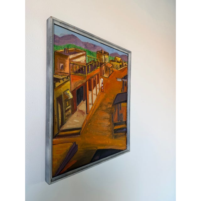 Charming 1970s oil on canvas depicting a quiet Southwestern-style town street with adobe-inspired architecture, wooden...