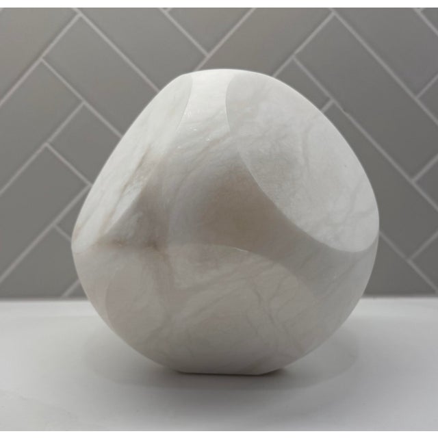 Sculptural alabaster object by Global Views, designed with softly faceted sides and a substantial, geometric form. Crafted...