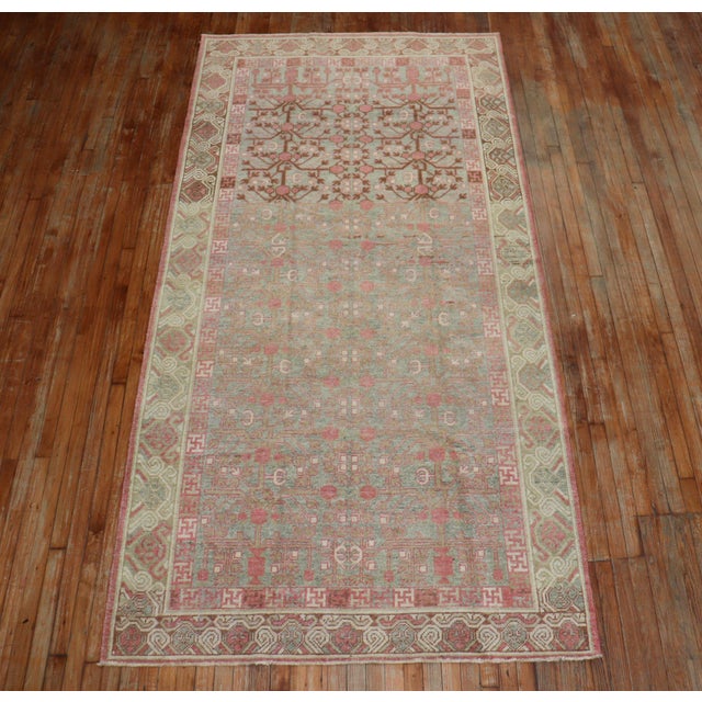 a Pink and celadon Green Gallery size Khotan, circa 1930 Details rug no. j2103 size 5' 1" x 10' 4" (155 x 315 cm)