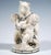 Excellent art nouveau ceramic piece in a rare version: two naked cherubs holding a bear standing upright between them,...