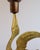 A pair of Scandinavian brass candleholders, each shaped as a stylised bird with an elongated neck supporting a copper...