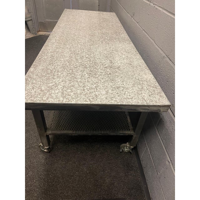 Metallic Industrial Table Circa 2020 Tabletop: 84" x 30" Bottom Shelf 71" x 25" Height (Wheel to table top) 29" Shelf...