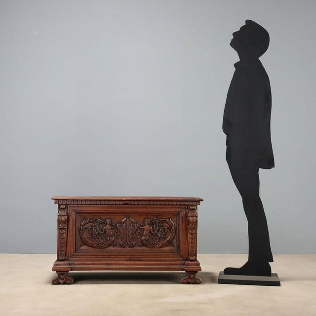 Walnut chest, a masterful modification of an original Baroque chest, resized in the 20th century in Italy. The front...