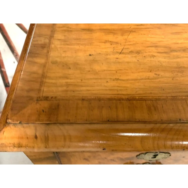 An English Queen Anne style walnut writing desk with satinwood cross banding, molded edge top, three drawers, brass pulls...