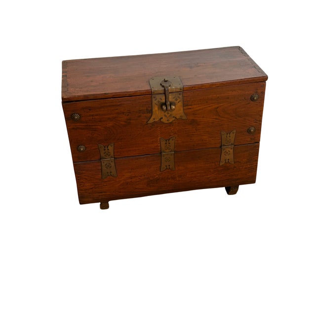 Constructed from sturdy elmwood and adorned with ornate iron hardware, this chest embodies the timeless beauty and...