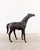 Exquisite mid-century sculptural horse, artfully wrapped in leather, complete with a saddle, bridle, and brass stirrups....
