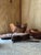 A curated collection of hand-carved olive wood serveware, each piece shaped from a single block of wood and finished to...