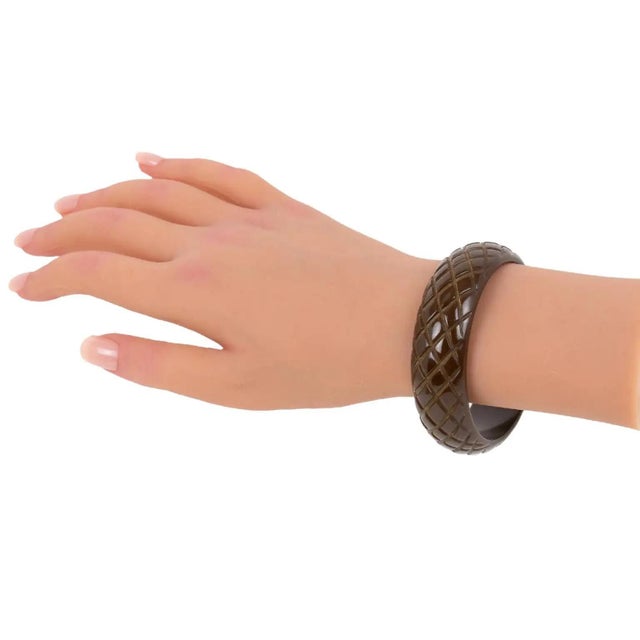 This stunning cocoa brown Bakelite carved bracelet bangle features a chunky domed shape with deep pineapple carving. The...