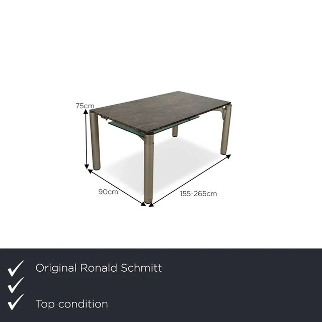 The dining table 801 E by Ronald Schmitt consists of a stone slab and stands on round table legs. It is characterized by...