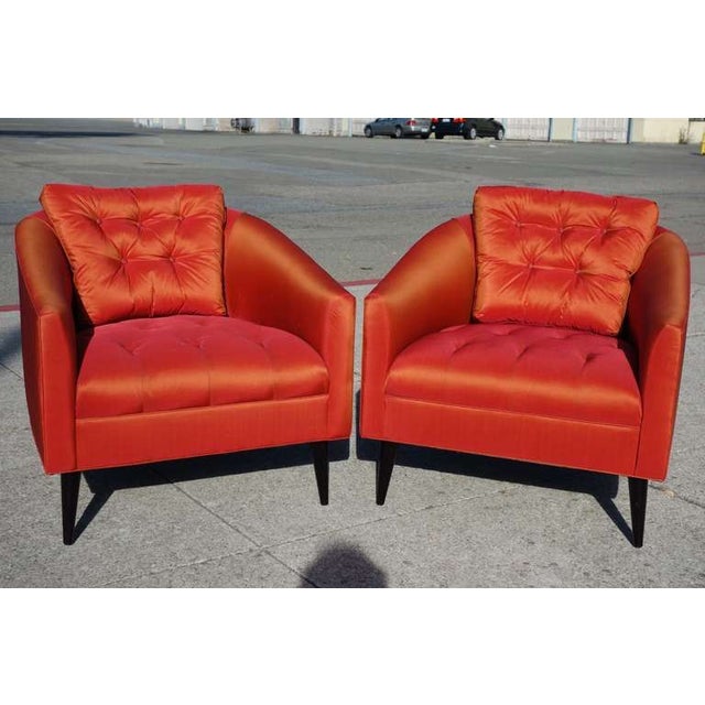 A gorgeous pair of red/orange silk/satin chairs. Beautiful tufting adds the perfect detail to these comfortable chairs....