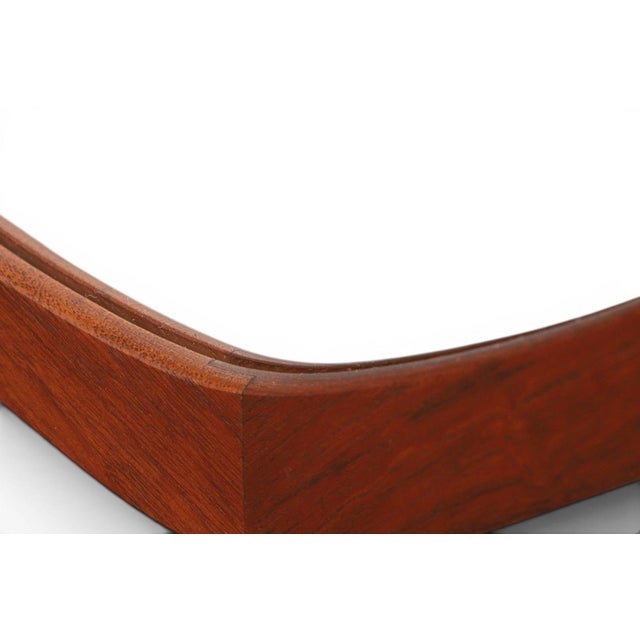 A beautifully composed 1950s Danish wall mirror with an asymmetrical atomic-age teak frame. The organic, off-center design...