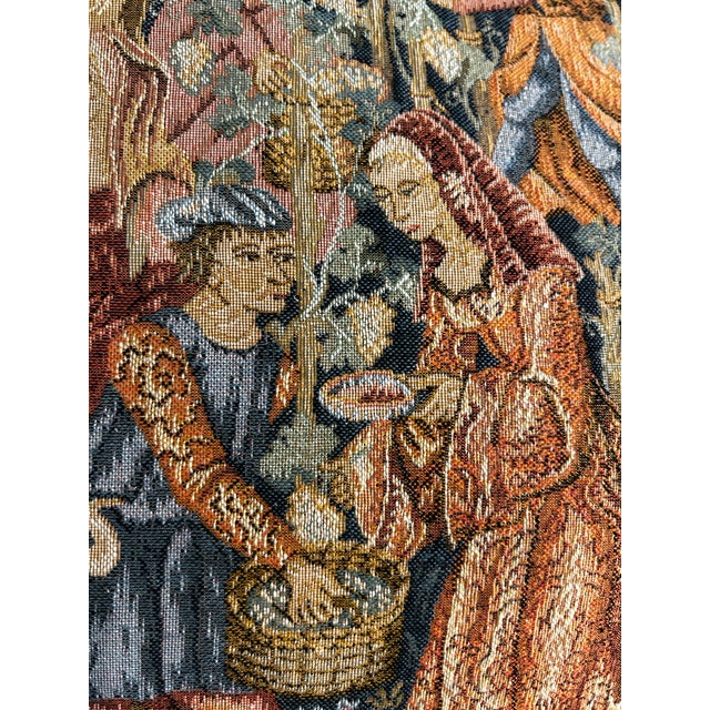A charming English-made tapestry pillow featuring a richly woven medieval courtly garden scene inspired by historic...