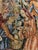A charming English-made tapestry pillow featuring a richly woven medieval courtly garden scene inspired by historic...