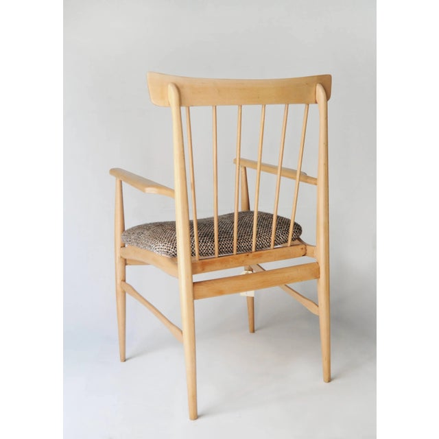 Armchair made from solid beechwood, backrest with bars and seat upholstered in tweed.