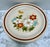 Midcentury set of five whimsical stoneware dinner plates called “Highland Flowers” made in Japan featuring a cheerful...